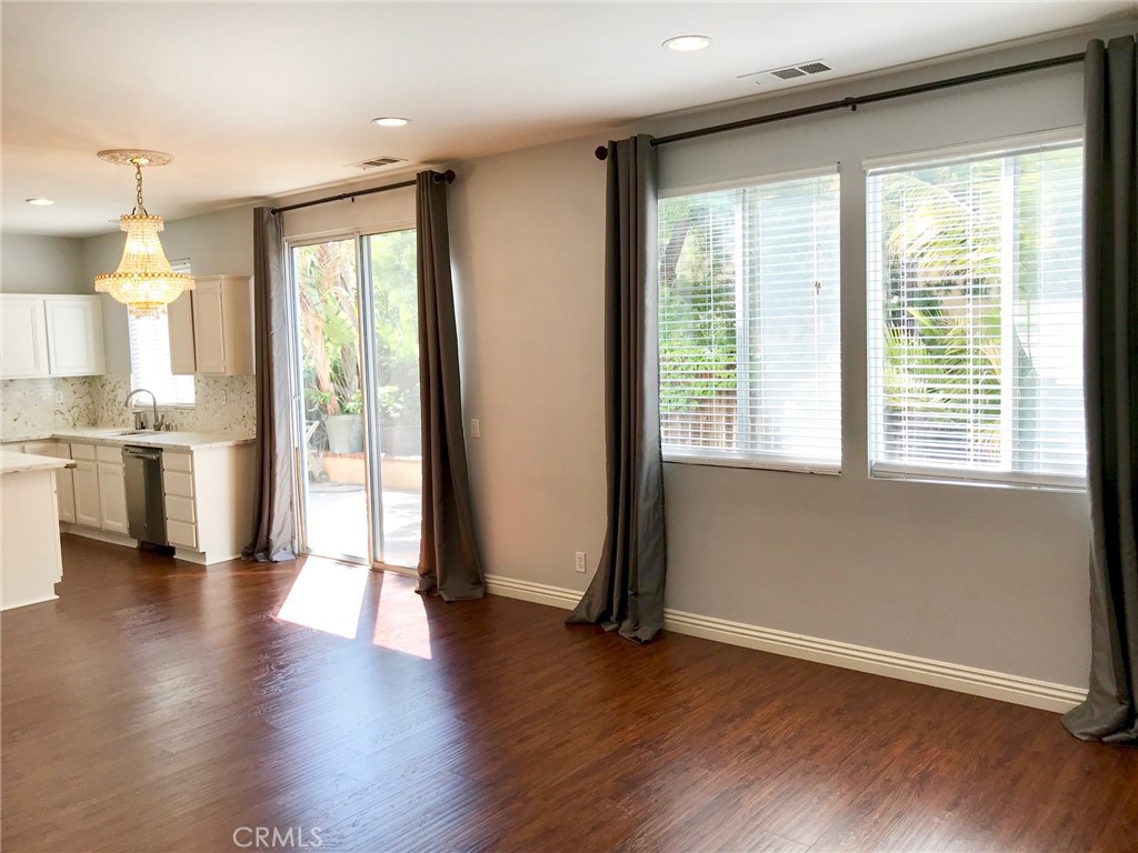 15 Brookhollow Irvine, CA 92602 - Photo 2 of 8 a view of empty room with wooden floor and fan