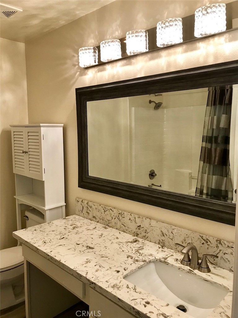 15 Brookhollow Irvine, CA 92602 - Photo 5 of 8 a bathroom with a sink and a mirror