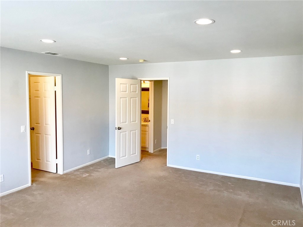 15 Brookhollow Irvine, CA 92602 - Photo 6 of 8 an empty room with a closet and wooden door