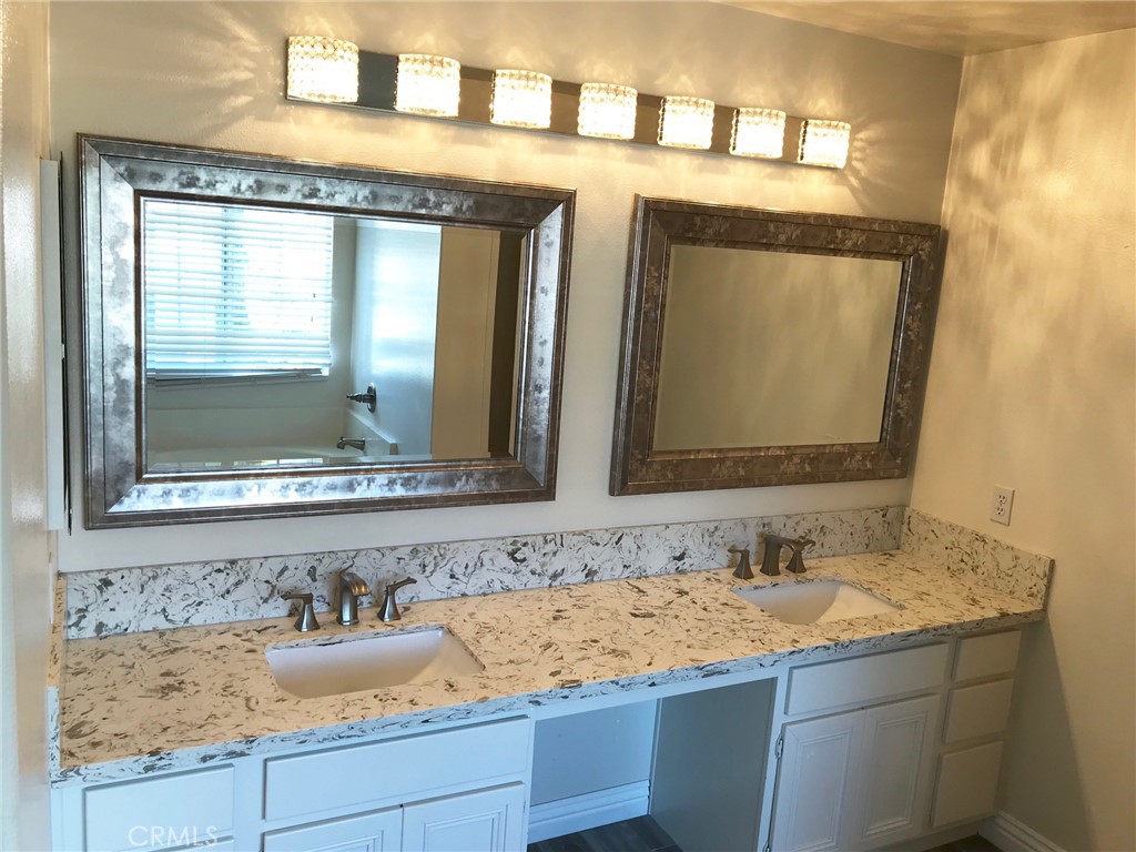 15 Brookhollow Irvine, CA 92602 - Photo 7 of 8 a bathroom with a granite countertop sink and a mirror