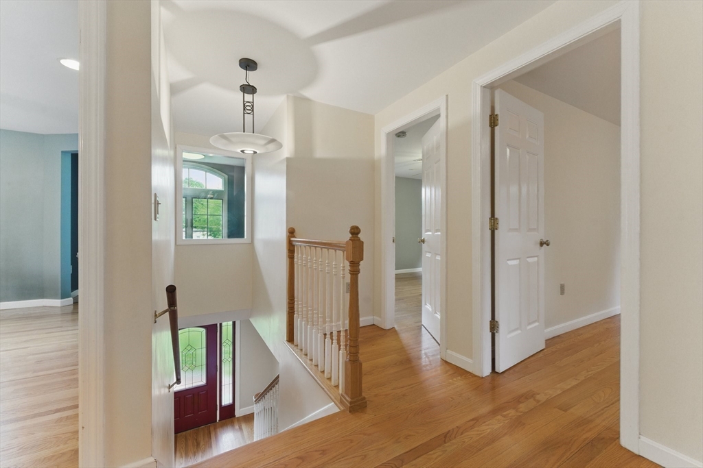 6 Willow Park Wellesley, MA 02481 - Photo 18 of 37 a view of a hallway with wooden floor and staircase
