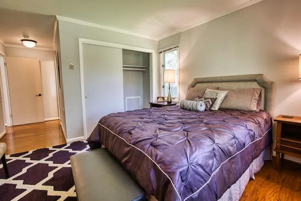 a bedroom with a bed and a window
