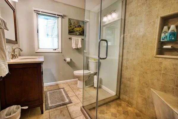 a bathroom with a sink mirror and a shower