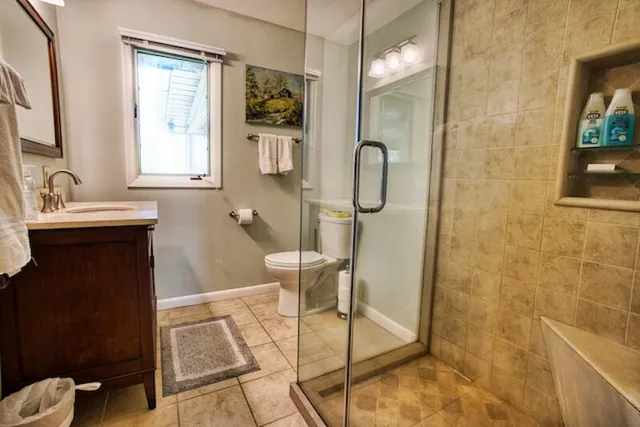 a bathroom with a sink mirror and a shower