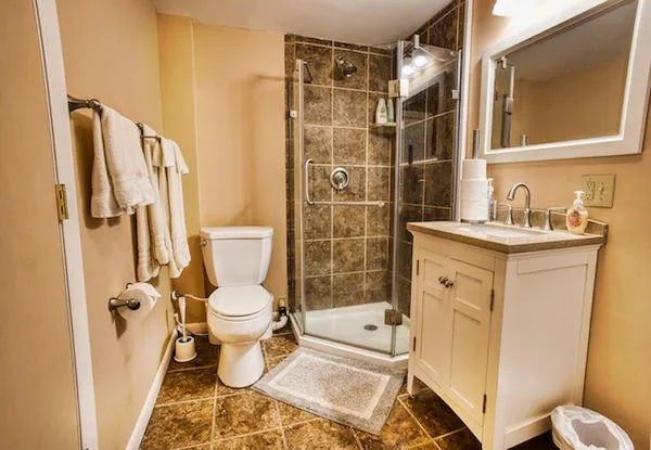 a bathroom with a sink toilet and shower