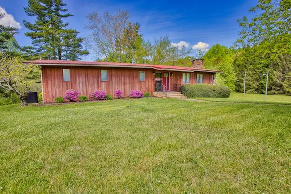 a view of a back yard of the house with green space