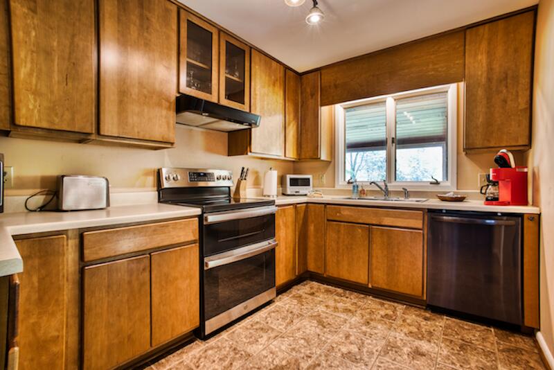 1436 Mayberry Church Road Meadows Of Dan, VA 24120 - Photo 10 of 38 a kitchen with stainless steel appliances granite countertop a sink stove and cabinets