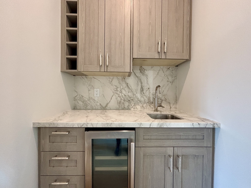 246 Newbury Street, Unit PH Boston, MA 02116 - Photo 12 of 22 a kitchen with granite countertop white cabinets and a sink