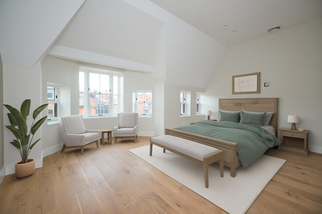 246 Newbury Street, Unit PH Boston, MA 02116 - Photo 14 of 22 a spacious bedroom with a bed and a couch