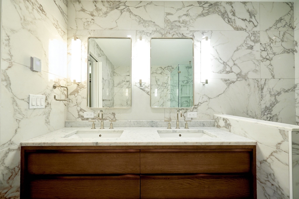 246 Newbury Street, Unit PH Boston, MA 02116 - Photo 17 of 22 a bathroom with a sink and a mirror
