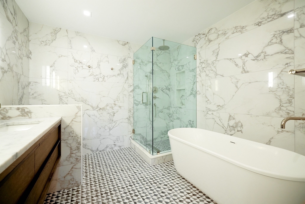 246 Newbury Street, Unit PH Boston, MA 02116 - Photo 18 of 22 a bathroom with a bathtub a sink a toilet and shower