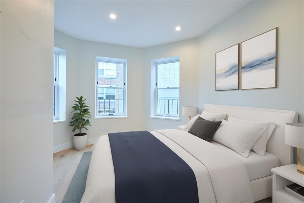 246 Newbury Street, Unit PH Boston, MA 02116 - Photo 19 of 22 a bedroom with a bed and a potted plant
