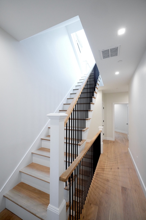 246 Newbury Street, Unit PH Boston, MA 02116 - Photo 21 of 22 a view of staircase with wooden floor and white walls