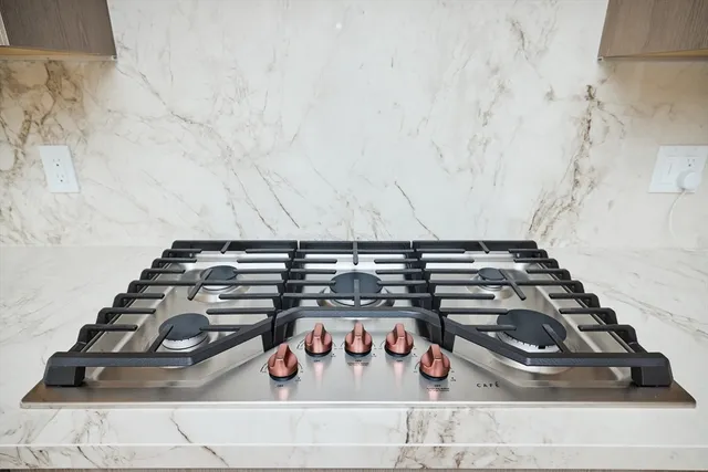 a kitchen with granite countertop white cabinets and a sink