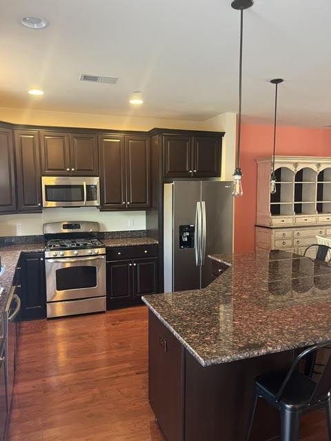 2212 Rising Hill Road Whitehall, PA 18052 - Photo 7 of 21 A well-appointed culinary space featuring rich wood cabinetry and gleaming stainless steel appliances.