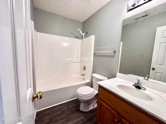 a bathroom with a sink toilet a mirror and shower
