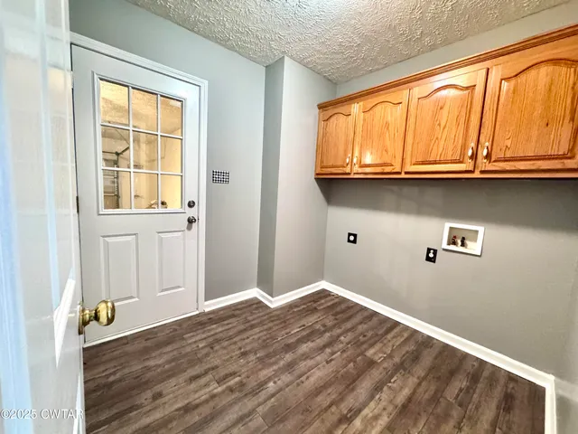 a view of a kitchen with wooden floor and a window