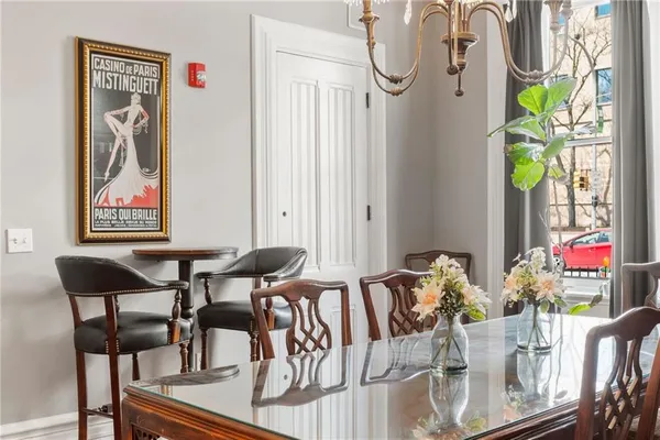 a view of a dining room with furniture one side kitchen view