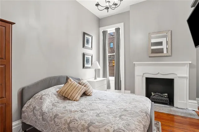 a bedroom with a bed and a fireplace