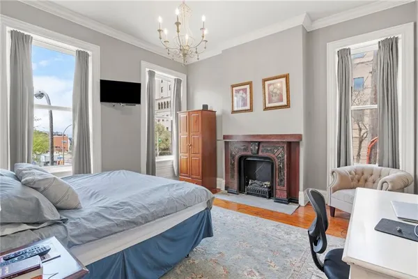 a bedroom with a bed and a fireplace