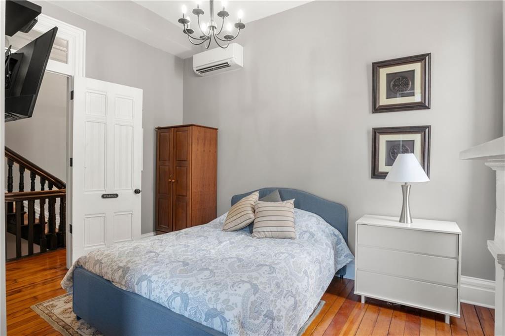 1010 Cedar Avenue Pittsburgh, PA 15212 - Photo 32 of 50 a bedroom with a bed and a chandelier