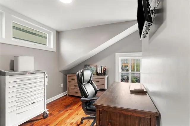 a view of a workspace with furniture and a window