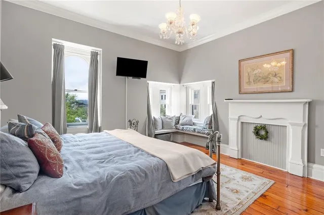 a spacious bedroom with a bed and a flat screen tv