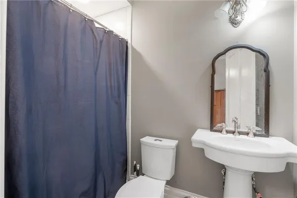 a bedroom with a bed closet and a flat tv screen