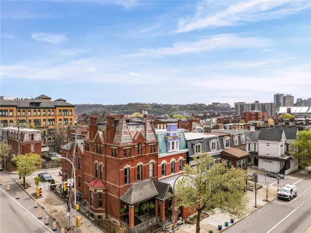 a view of a building from a chairs and table in the balcony