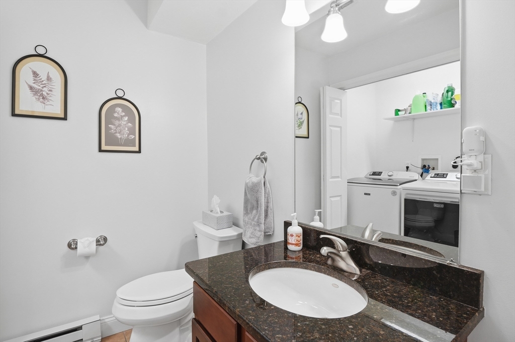25 Greeley Street, Unit 2 Clinton, MA 01510 - Photo 16 of 33 a bathroom with a toilet a sink a mirror and vanity