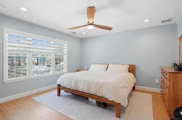 a bedroom with a bed lamp and window