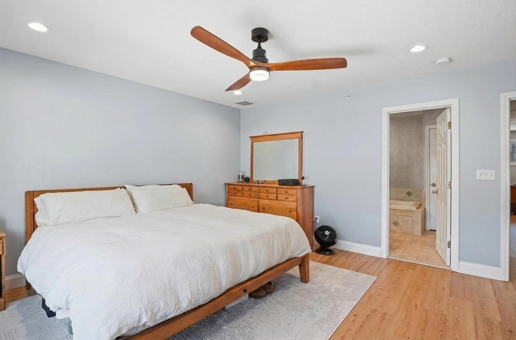 25 Greeley Street, Unit 2 Clinton, MA 01510 - Photo 20 of 33 a bedroom with a bed and a ceiling fan