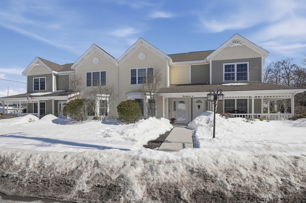 25 Greeley Street, Unit 2 Clinton, MA 01510 - Photo 2 of 33 a view of a white house with a yard and sitting area