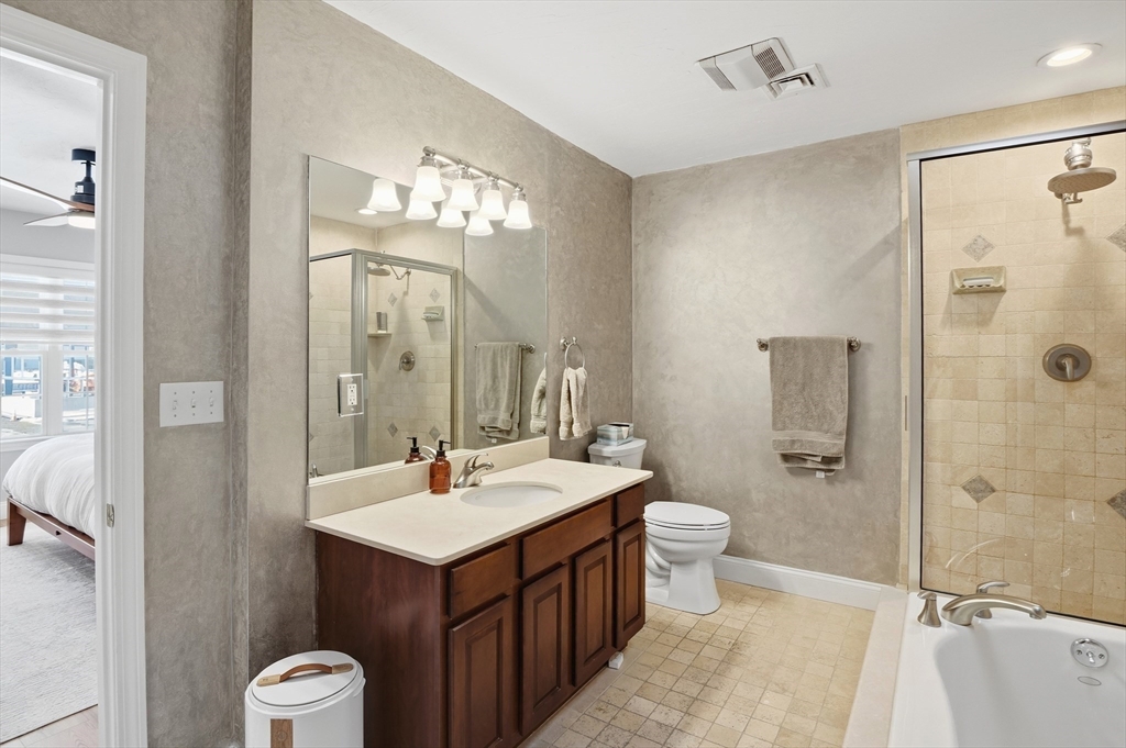 25 Greeley Street, Unit 2 Clinton, MA 01510 - Photo 22 of 33 a bathroom with a double vanity sink toilet mirror and shower