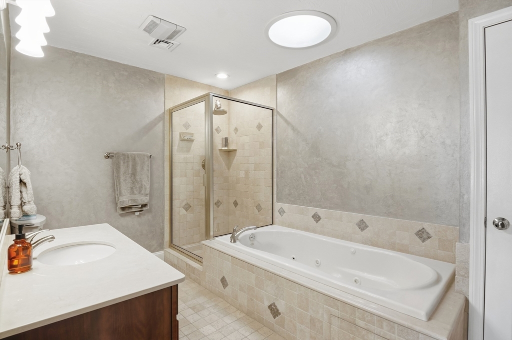 25 Greeley Street, Unit 2 Clinton, MA 01510 - Photo 23 of 33 a bathroom with a tub sink and mirror