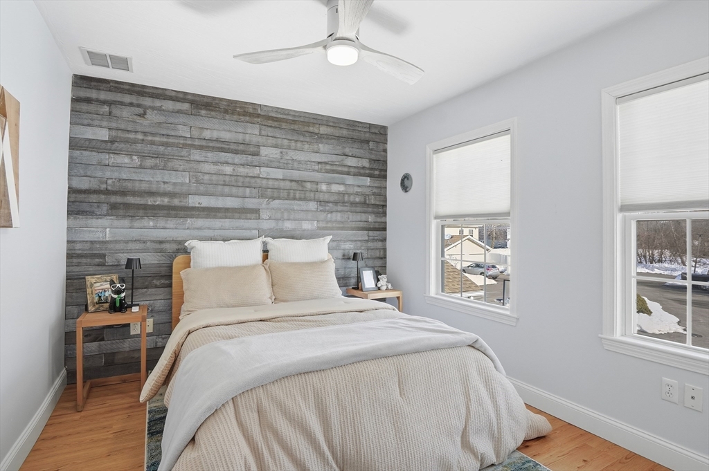 25 Greeley Street, Unit 2 Clinton, MA 01510 - Photo 25 of 33 a bed sitting in a bedroom next to a window