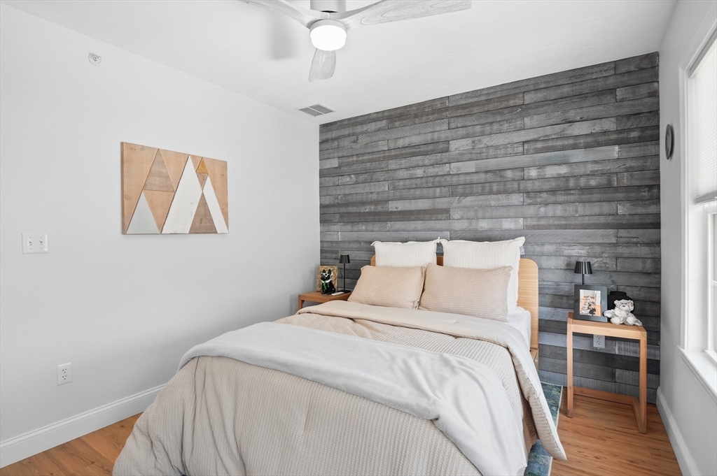 25 Greeley Street, Unit 2 Clinton, MA 01510 - Photo 26 of 33 a bedroom with a bed and a painting on the wall