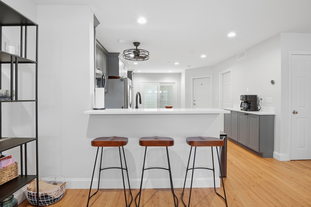 25 Greeley Street, Unit 2 Clinton, MA 01510 - Photo 9 of 33 a kitchen with stainless steel appliances kitchen island a chandelier