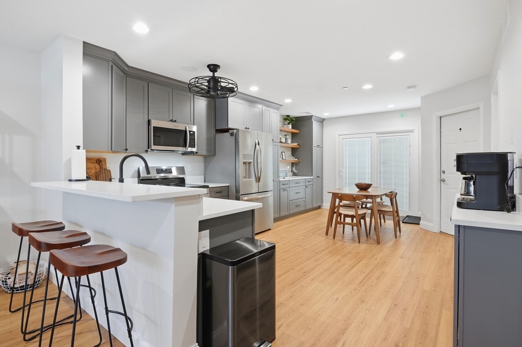 25 Greeley Street, Unit 2 Clinton, MA 01510 - Photo 10 of 33 a kitchen with stainless steel appliances kitchen island granite countertop a sink and cabinets