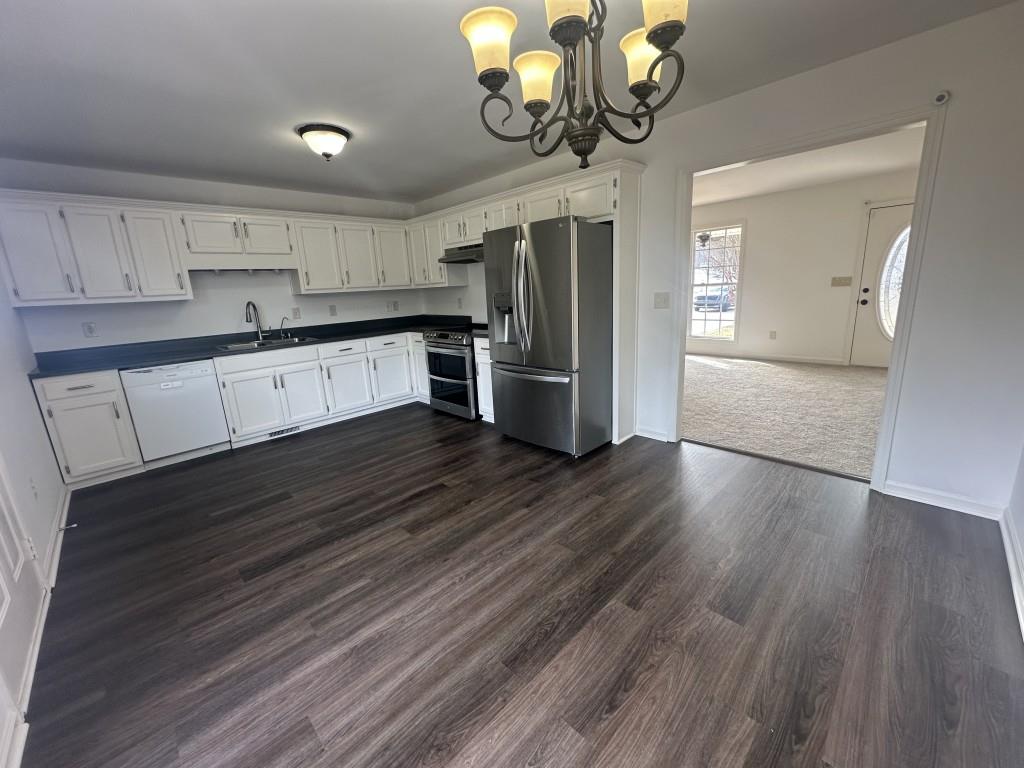 205 Daisy Lane Chatsworth, GA 30705 - Photo 11 of 34 a kitchen with stainless steel appliances granite countertop a wooden floors