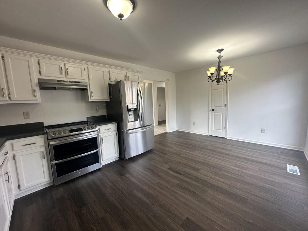 205 Daisy Lane Chatsworth, GA 30705 - Photo 13 of 34 a kitchen with stainless steel appliances a stove top oven and cabinets