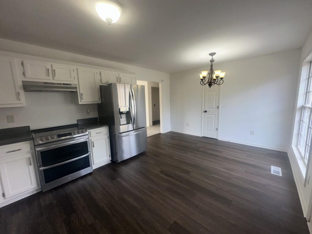 205 Daisy Lane Chatsworth, GA 30705 - Photo 14 of 34 a kitchen with stainless steel appliances a stove and wooden floor