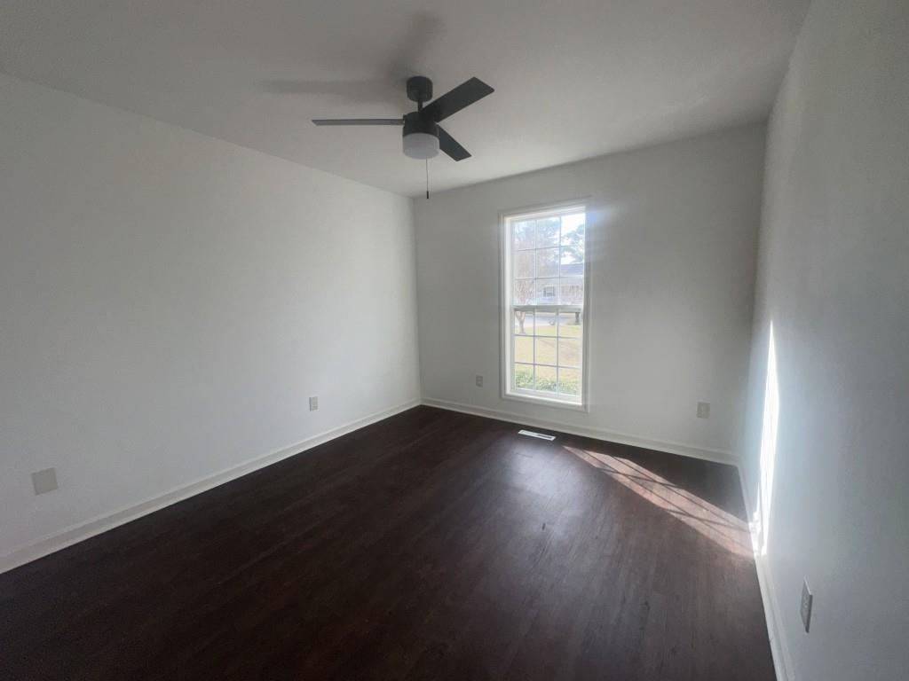 205 Daisy Lane Chatsworth, GA 30705 - Photo 24 of 34 an empty room with wooden floor and windows