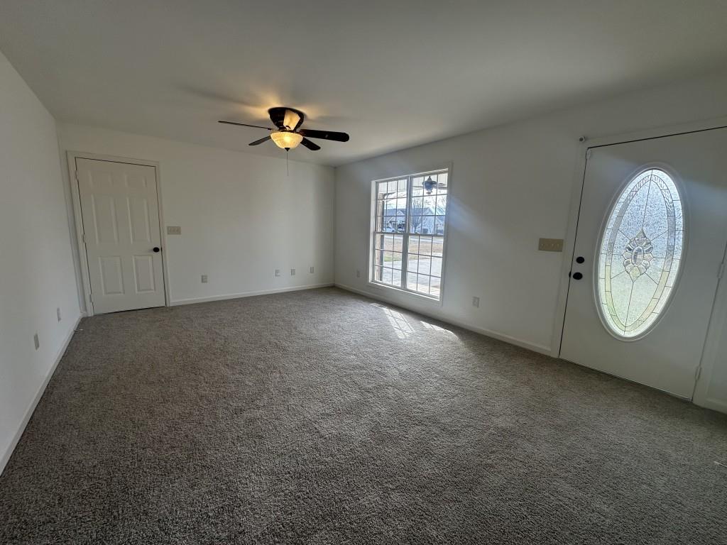 205 Daisy Lane Chatsworth, GA 30705 - Photo 6 of 34 an empty room with windows and fan