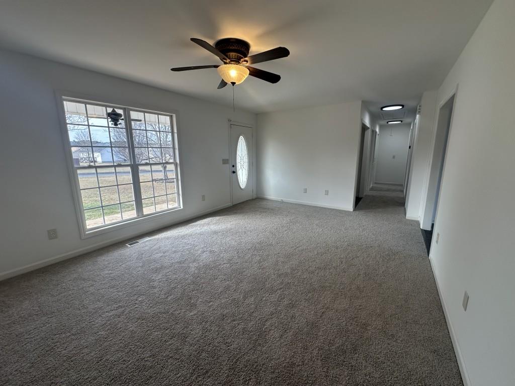 205 Daisy Lane Chatsworth, GA 30705 - Photo 8 of 34 an empty room with chandelier fan and windows