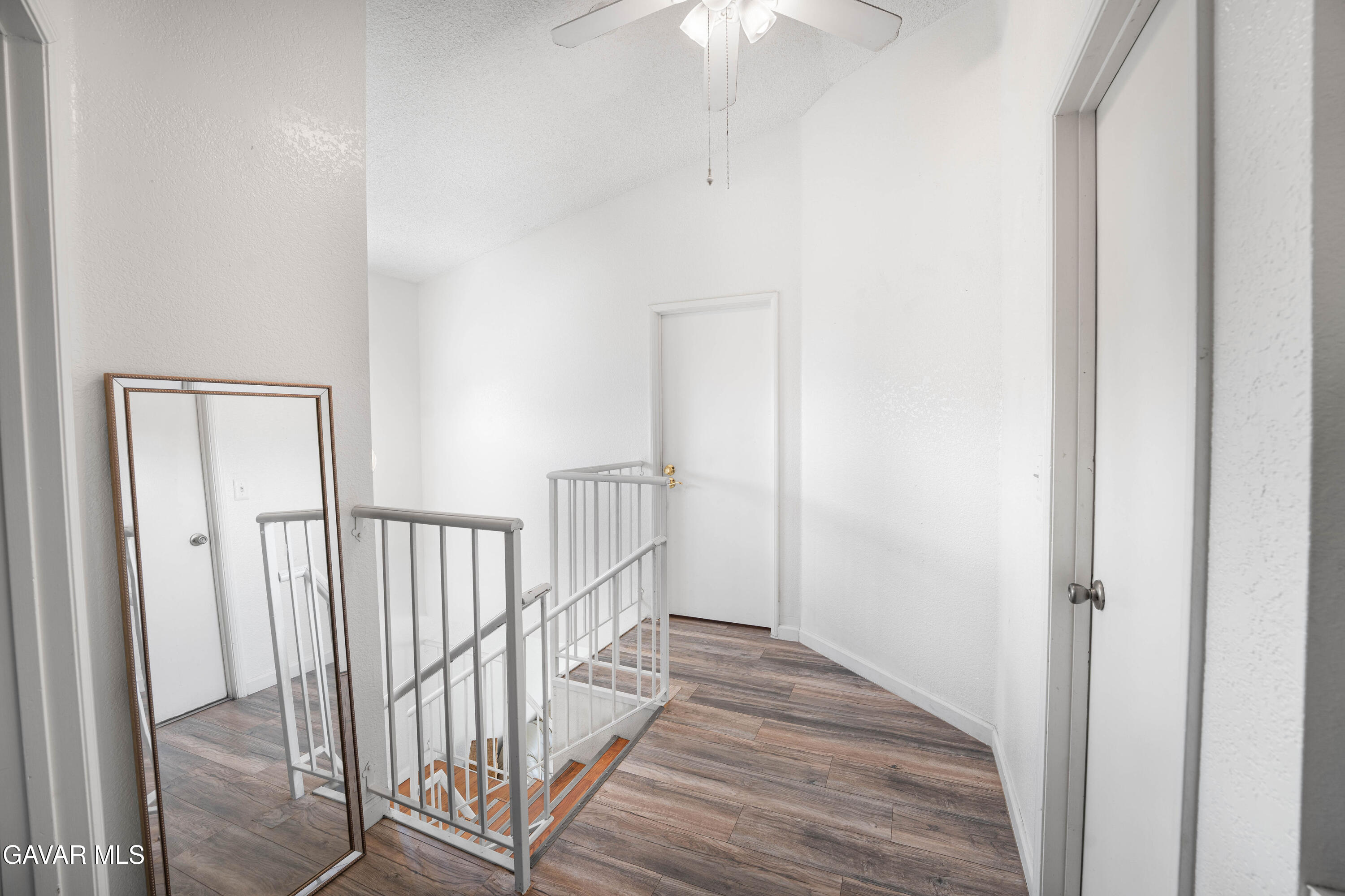 5009 East Ave R 11 Palmdale, CA 93552 - Photo 17 of 23 a view of a hallway with wooden floor