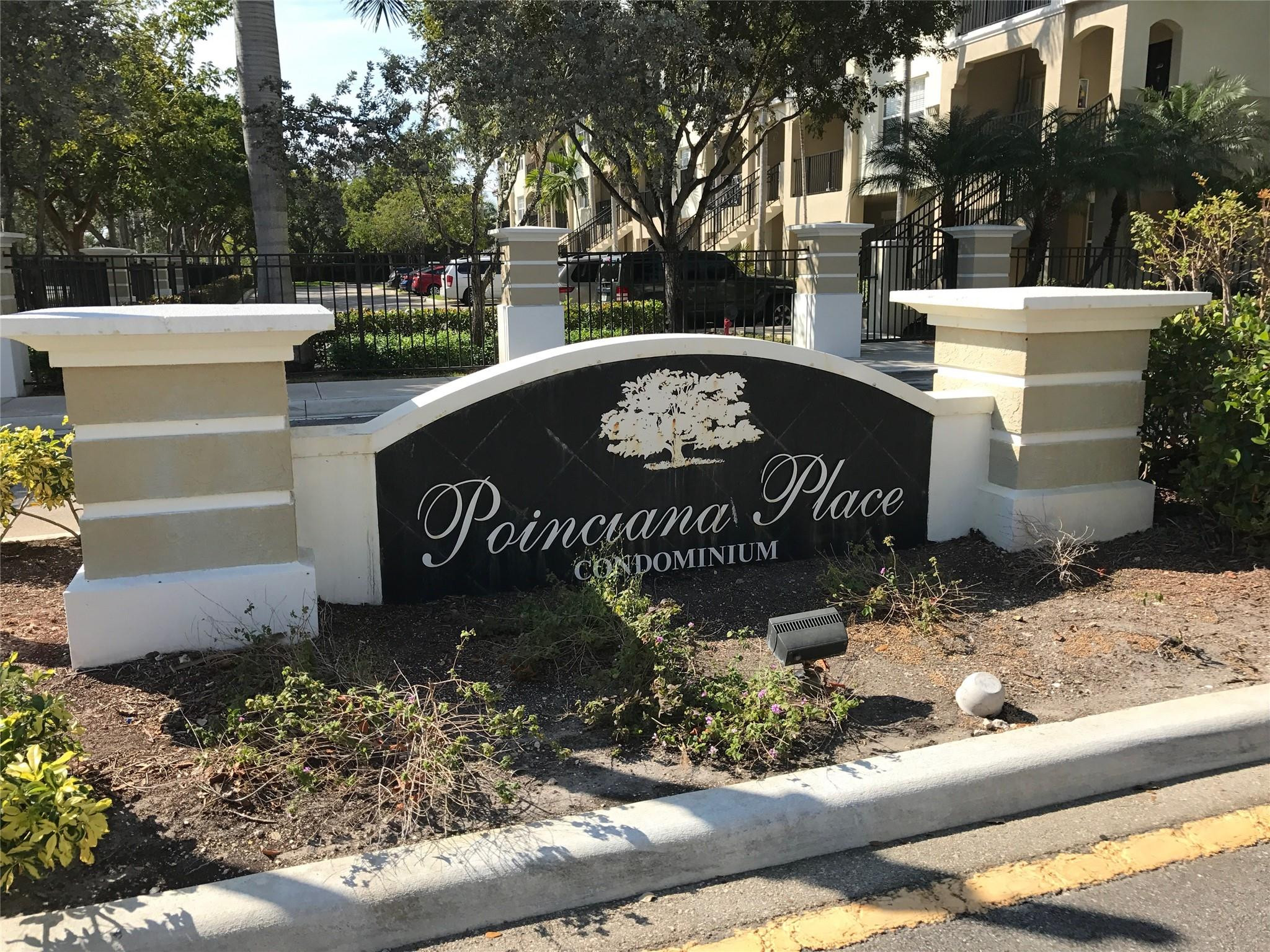 5800 West Sample Road, Unit 305 Coral Springs, FL 33067 - Photo 14 of 28 a view of a park that has a sign board and trees