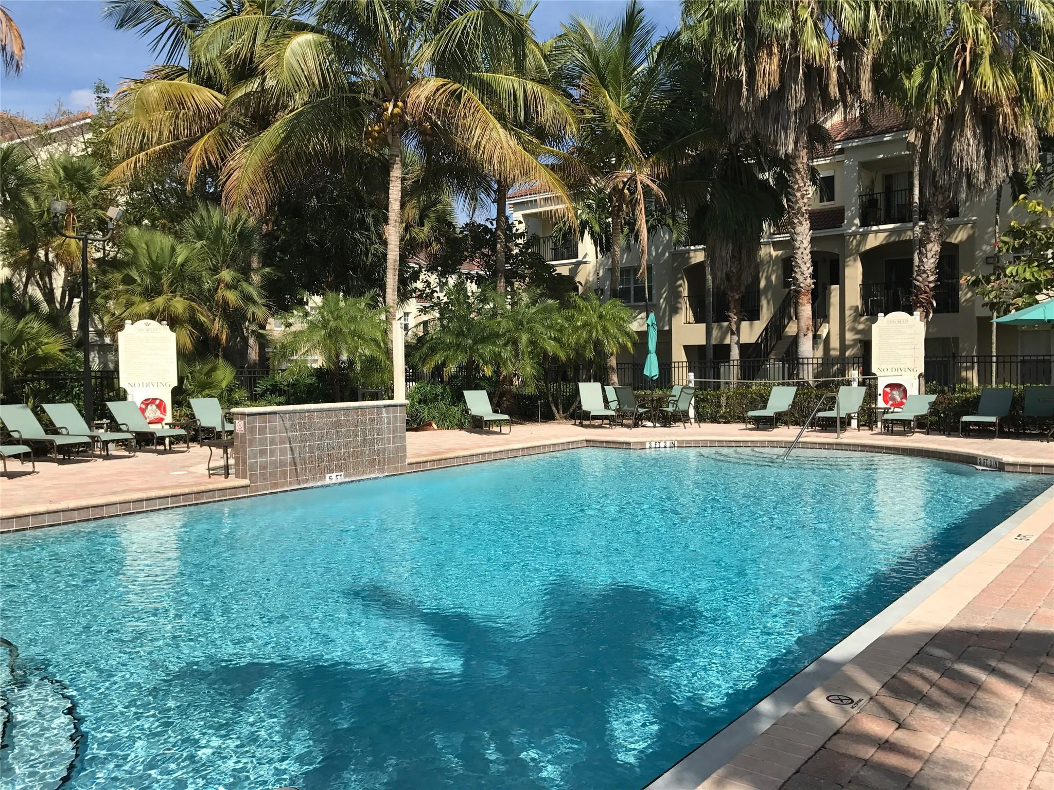 5800 West Sample Road, Unit 305 Coral Springs, FL 33067 - Photo 17 of 28 a view of a fountain in front of a house