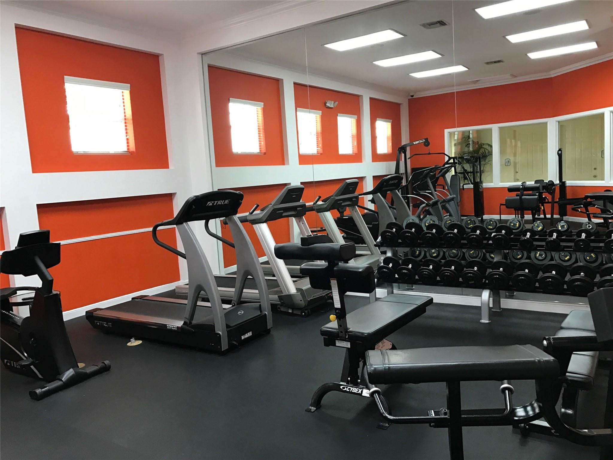5800 West Sample Road, Unit 305 Coral Springs, FL 33067 - Photo 20 of 28 a room with gym equipment and windows