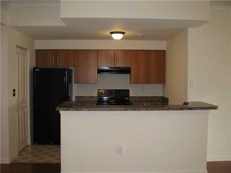 5800 West Sample Road, Unit 305 Coral Springs, FL 33067 - Photo 2 of 28 a kitchen with stainless steel appliances granite countertop a refrigerator and a stove